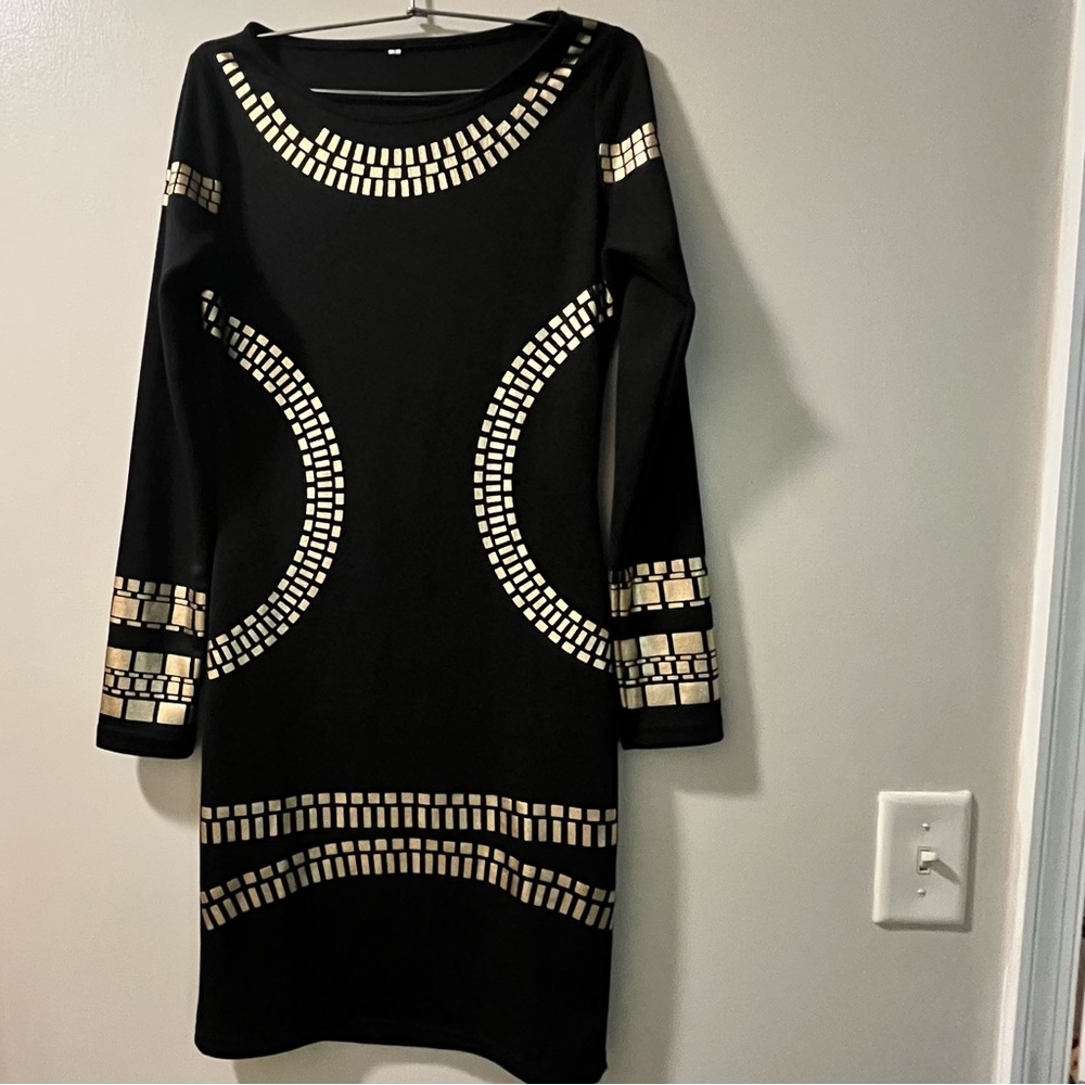 New without tags. Sexy black dress with Egyptian style foil